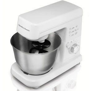 Front angle view of this mixer, with flat beater installed, mixing bowl placed on base, and head in working position
